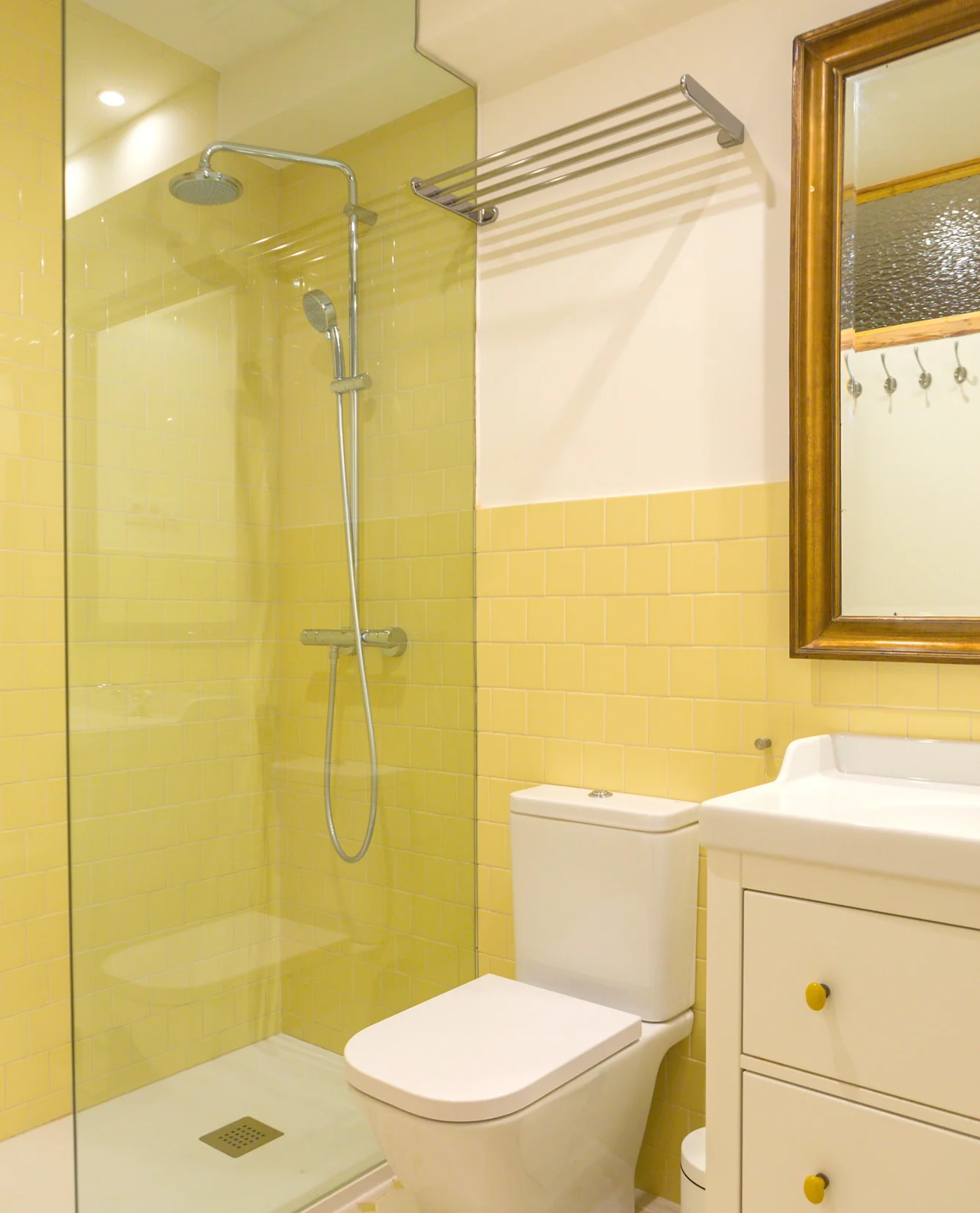 Baño con azulejos amarillos y ducha de cristal.. Fotografía 8